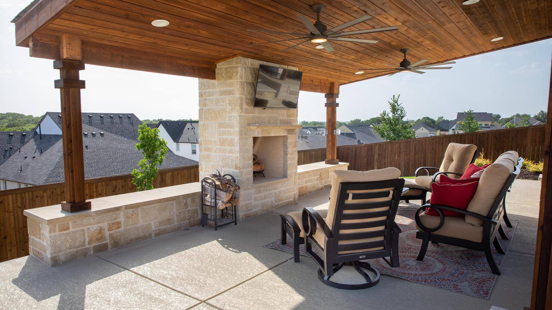 Outdoor living space with a covered patio, fireplace, and comfortable seating