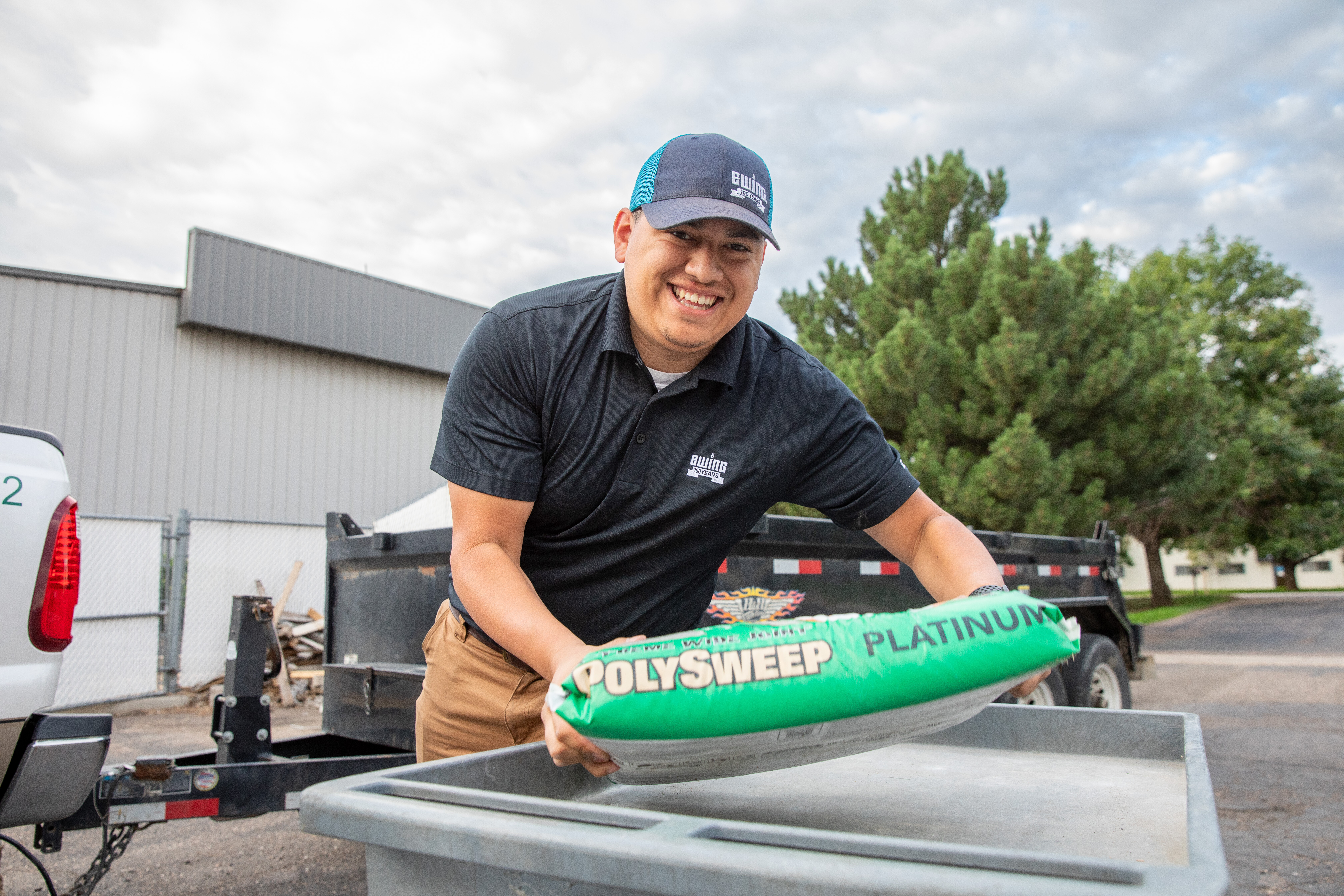 Ewing employee in Fort Collins, Colorado, placing Polysweep bag on cart (Photo courtesy of Kyle Ellsworth/Ewing Outdoor Supply)