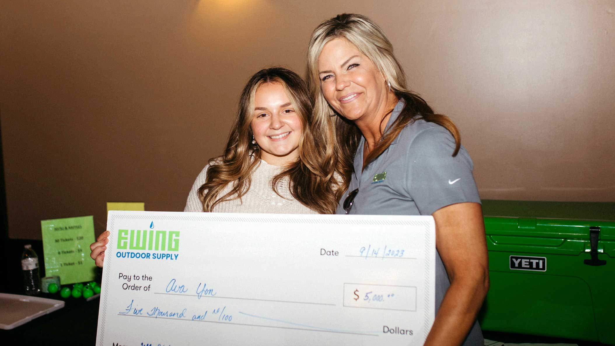School girl receiving scholarship check.