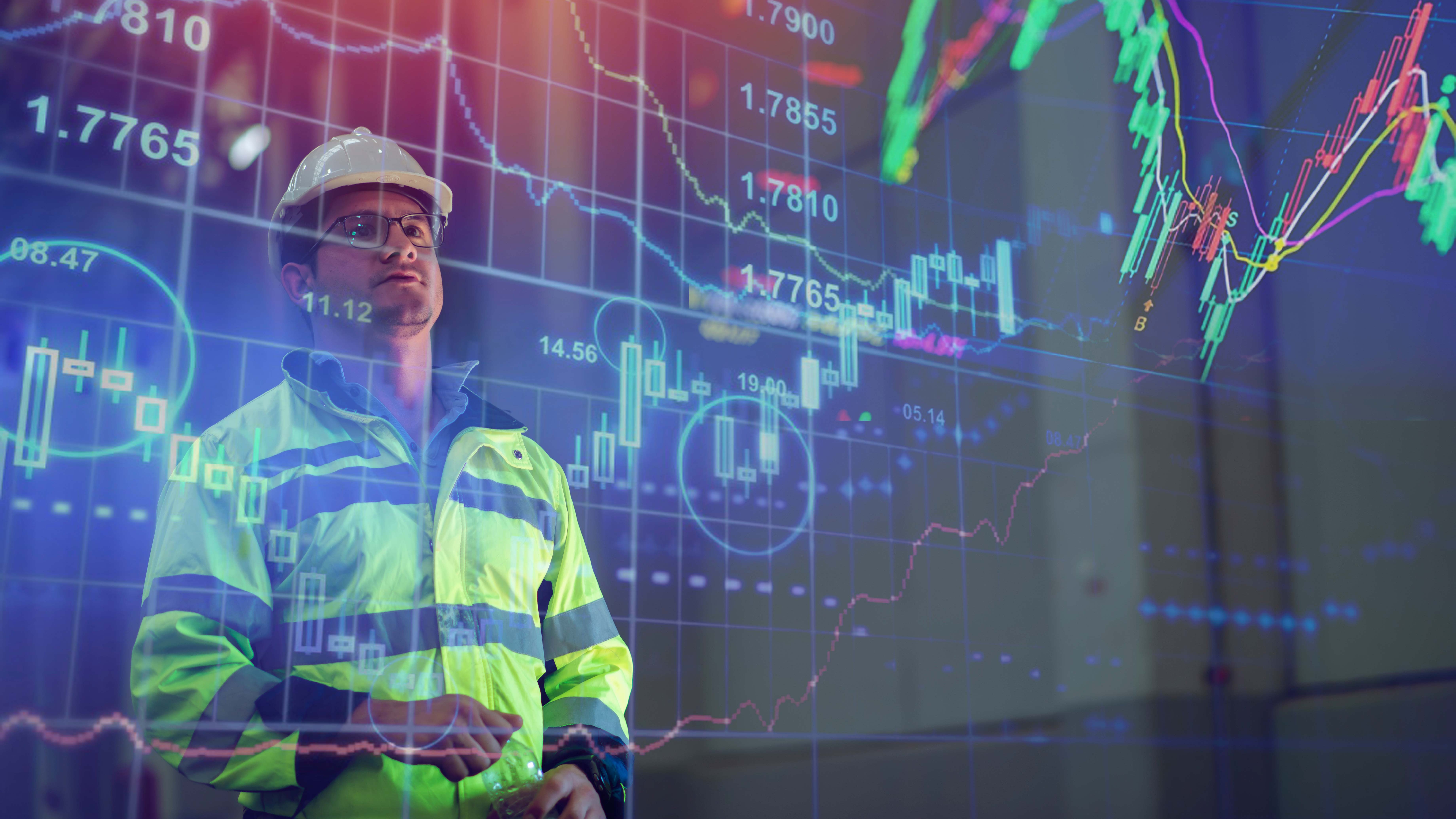 A man analyzing a display of graphs and information.