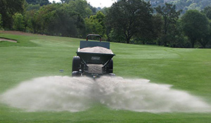 Golf course fairway being topdressed with sand using a Turfco spreader